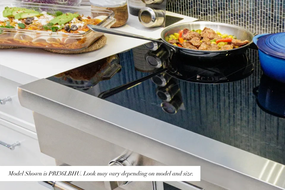 Frameless black glass cooktop covers the surface