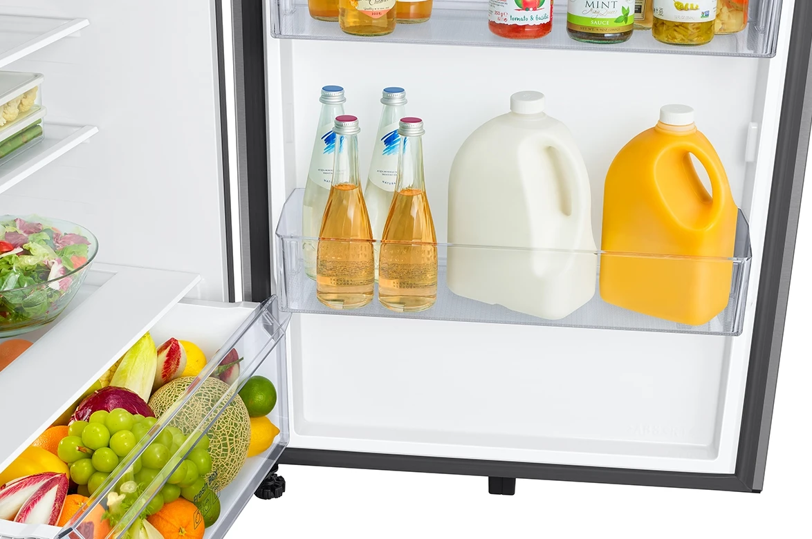 Top freezer refrigerator with door shelves for beverages and gallons, plus fresh produce below